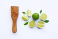 Limes with wooden lime Squeezer on white