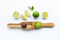 Limes with wooden lime Squeezer on white