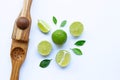 Limes with wooden lime Squeezer on white