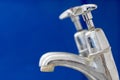 Limescale. Chrome faucet tap with hard water calcification deposit close-up