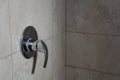 Limescale deposits on the water control handle in the shower. Selective focus, shallow depth of field Royalty Free Stock Photo