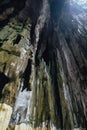 Limestone cave texture with green and sun light inside Batu Caves near Kuala Lumpur, Malaysia. Royalty Free Stock Photo