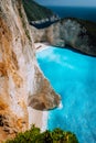 Limestone chalk colored like huge cliff rocks surrounding Navagio beach with Shipwreck and azure blue sea water Royalty Free Stock Photo