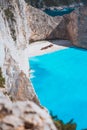 Limestone chalk colored like huge cliff rocks surrounding Navagio beach with Shipwreck and azure blue sea water Royalty Free Stock Photo