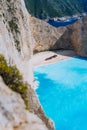 Limestone chalk colored like huge cliff rocks surrounding Navagio beach with Shipwreck and azure blue sea water Royalty Free Stock Photo