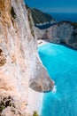 Limestone chalk colored like huge cliff rocks surrounding Navagio beach with Shipwreck and azure blue sea water Royalty Free Stock Photo