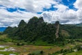Limestone cliffs rising above rice fields, Laos Royalty Free Stock Photo