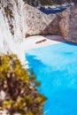 Limestone huge cliff rocks surrounding Navagio beach with Shipwreck and azure blue sea water. Zakynthos island, Greece Royalty Free Stock Photo