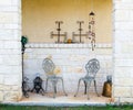 Limestone patio with wrought iron chairs and metal accessories