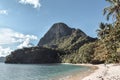 Limestone rock on a beautiful tropical Paradise beach full of palm trees in El Nido Palawan Island the Philippines Royalty Free Stock Photo