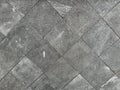 Limestone square tile arranged diagonally with rough texture