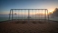 Empty Playground Swing Set at Sunrise. Royalty Free Stock Photo