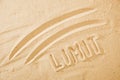 Limit concept, line and word on sand Royalty Free Stock Photo