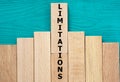 LIMITATIONS - word on wooden bars on a green background