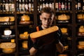 Limited gouda cheese in hands of cheese sommelier. Snack tasty piece of cheese for appetizer.