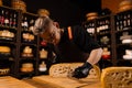 Limited maasdam cheese wheel cutting cheese in store. Cheese sommelier cuts yellow cheese wheel cut in half with a knife Royalty Free Stock Photo