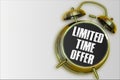 Limited time offer yellow alarm clock on grey background Royalty Free Stock Photo