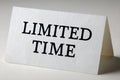 Limited time text on white folded tent card, closeup minimal urgency message on light background with shadow and copy space Royalty Free Stock Photo