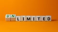 Limited or unlimited symbol. Turned wooden cubes and changed words `limited` to `unlimited`. Beautiful orange background, copy