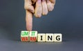 Limiting global warming symbol. Concept words Limiting and Warming on wooden cubes. Businessman hand. Beautiful grey table grey