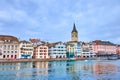 The medieval charm of old Zurich with wateerfront of Limmat River and Peterskirche\'s bell tower, Switzerland