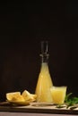 Limoncello lemon beverage on dark background.
