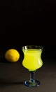 Limoncello Liqueur or poncha drink in a glass goblet with copy space with dark background and lemon Royalty Free Stock Photo