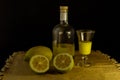 Limoncello traditional italian lemon liqueur with bottle, glass and fresh lemon halves Royalty Free Stock Photo