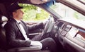 Limousine driver driving and smiling Royalty Free Stock Photo