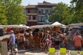 Limoux Aude France. Market square. Stall selling colourful bags and sun hats. Young family, three children . Mature man