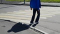 Limping a grown man enters the crosswalk. Puts his feet on tiptoe - disability with cerebral palsy