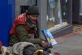 Big Issue Seller Sitting on the Pavement on Lincoln High Street
