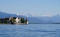 Lindau island on lake Constance (Bodensee) with snowy Swiss Alps in background, Germany on fine sunny spring day