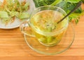 Linden tea in glass cup against of dried linden flowers Royalty Free Stock Photo