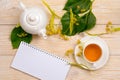 Linden herbal tea with empty notepad on wooden table Royalty Free Stock Photo