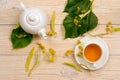 Linden herbal tea with raw plant on wooden table Royalty Free Stock Photo