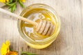 Linden honey in jar and calendula blossoms on wooden table Royalty Free Stock Photo