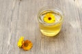 Linden honey in jar and calendula blossoms on wooden table Royalty Free Stock Photo