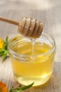 Linden honey in jar and calendula blossoms on wooden table Royalty Free Stock Photo