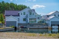 White wooden house with a canal and boat garage instead of a garden.. Royalty Free Stock Photo