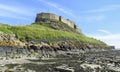 Lindisfarne Castle panoramic view from the beach, blue sky in a summer day, Holy Island, Northumberland Royalty Free Stock Photo