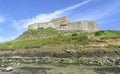 Lindisfarne Castle panoramic view from the beach in a sunny day, Holy Island, Northumberland Royalty Free Stock Photo