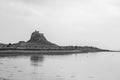 Holy Island Castle view from coastline with tide , in monochrome