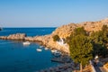 Lindos, Greece - August 11, 2018: Cove with acropolis located on a rock, Lindos city at sunset, Greece Royalty Free Stock Photo