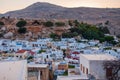 Lindos, Greece - August 11, 2018: Landscape of the white houses of the city of Lindos at sunset, Greece Royalty Free Stock Photo