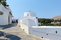 Narrow street with white houses at Lindos town on Rhodes island, Greece Royalty Free Stock Photo