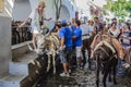 Lindos, Greece. Landing tourists for a trip to the acropolis of Lindos on donkeys.