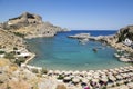 Lindos, Rhodes / GREECE - 7 September, 2018: One of the most amazing beaches on Rhodes with boats, sunbeds and sun umbrellas