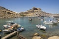 Lindos, Rhodes / GREECE - 7 September, 2018: One of the most amazing beaches on Rhodes with boats, sunbeds and sun umbrellas