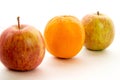 Line of apples with one orange Royalty Free Stock Photo